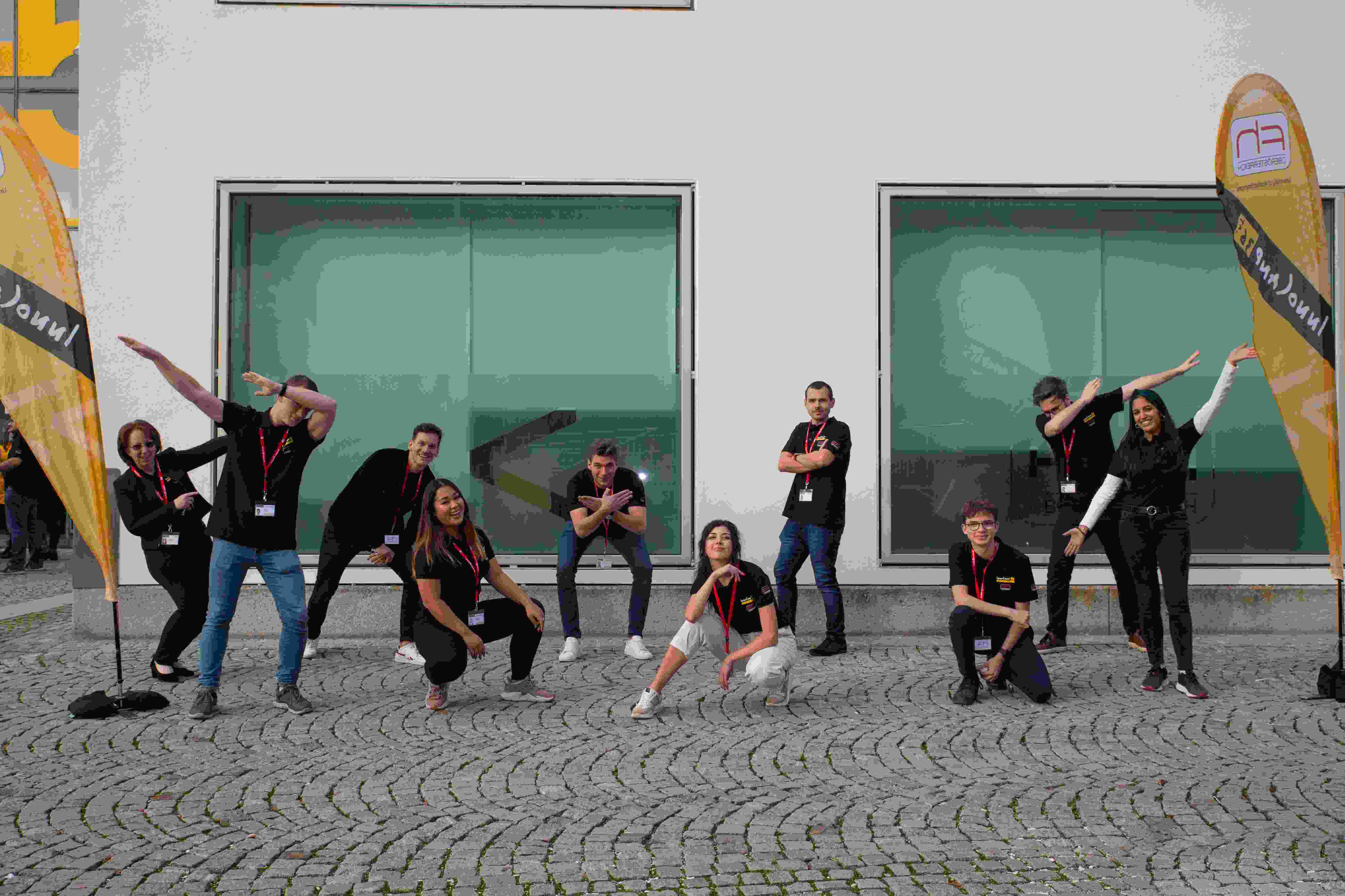 A group from Innocamp poses outdoors in front of a building.